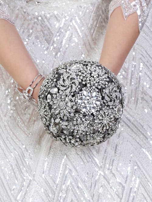 Free Person Holding a Silver Round Ball Stock Photo
