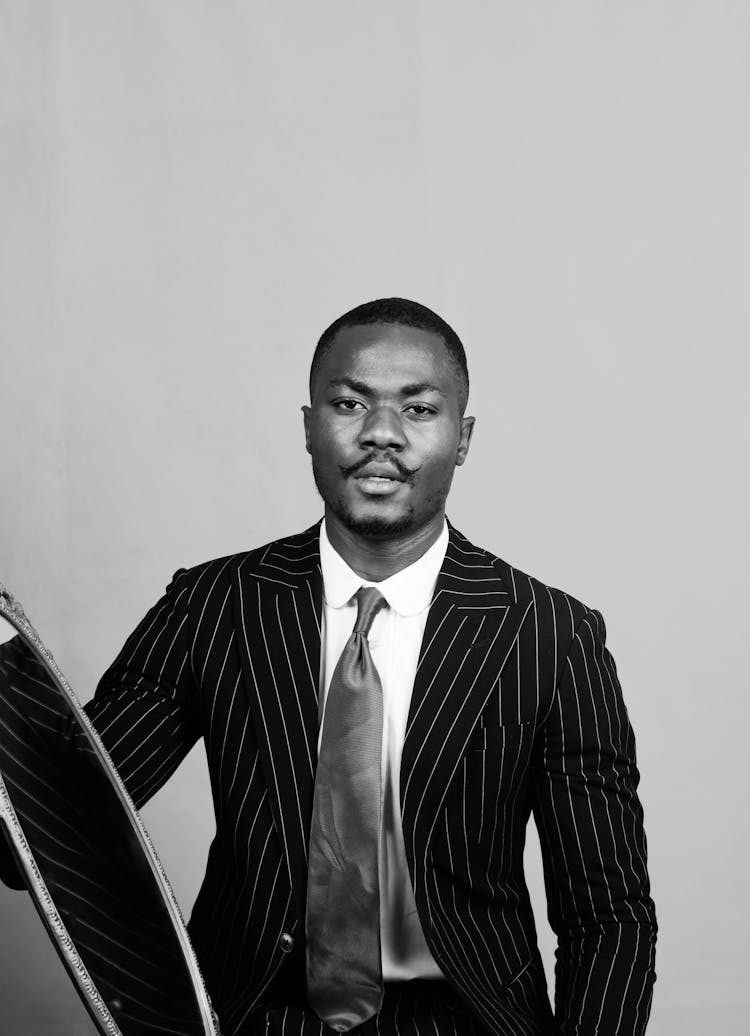 Serious Black Man In Suit And Tie With Mirror