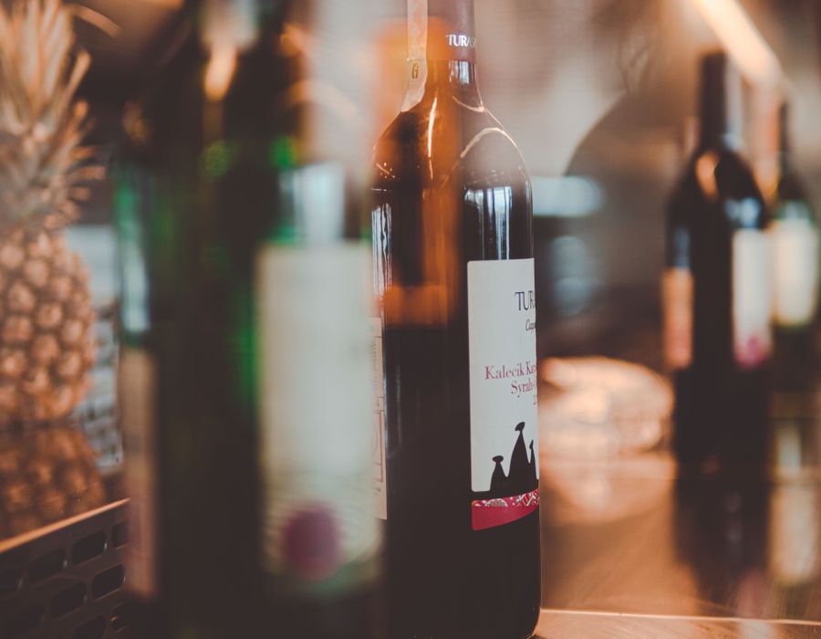 Wine bottles standing on a counter in warm light