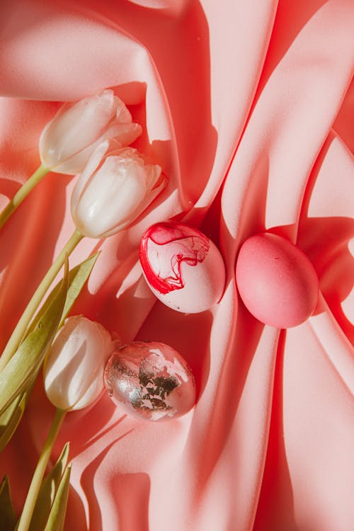 Red Tulips And Colored Eggs On Pink Textile
