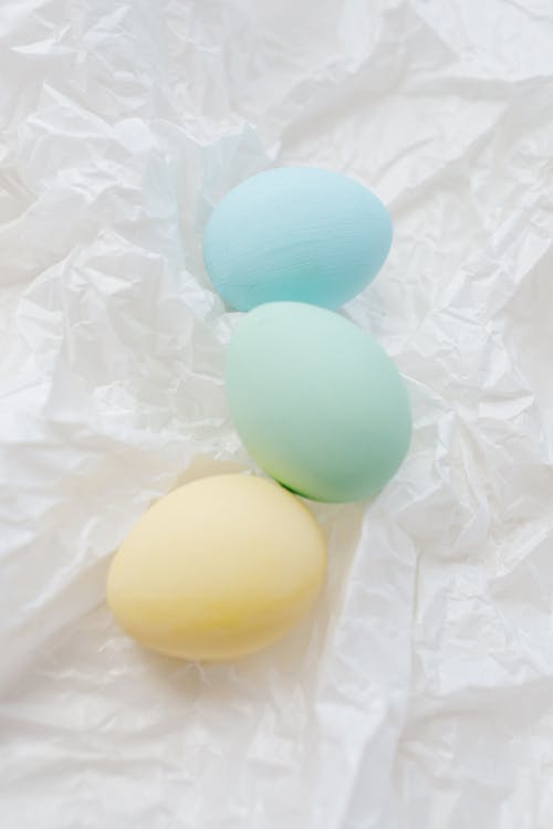 Three Colored Eggs On White Surface