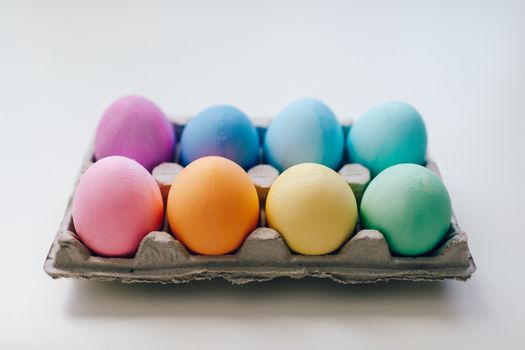 A vibrant set of pastel Easter eggs in a carton. Perfect decoration for the holiday season.