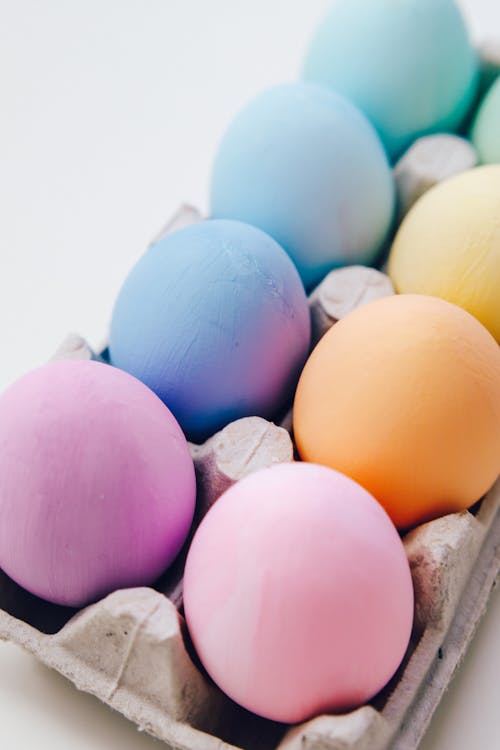 Pastel Colored Eggs In A Carton