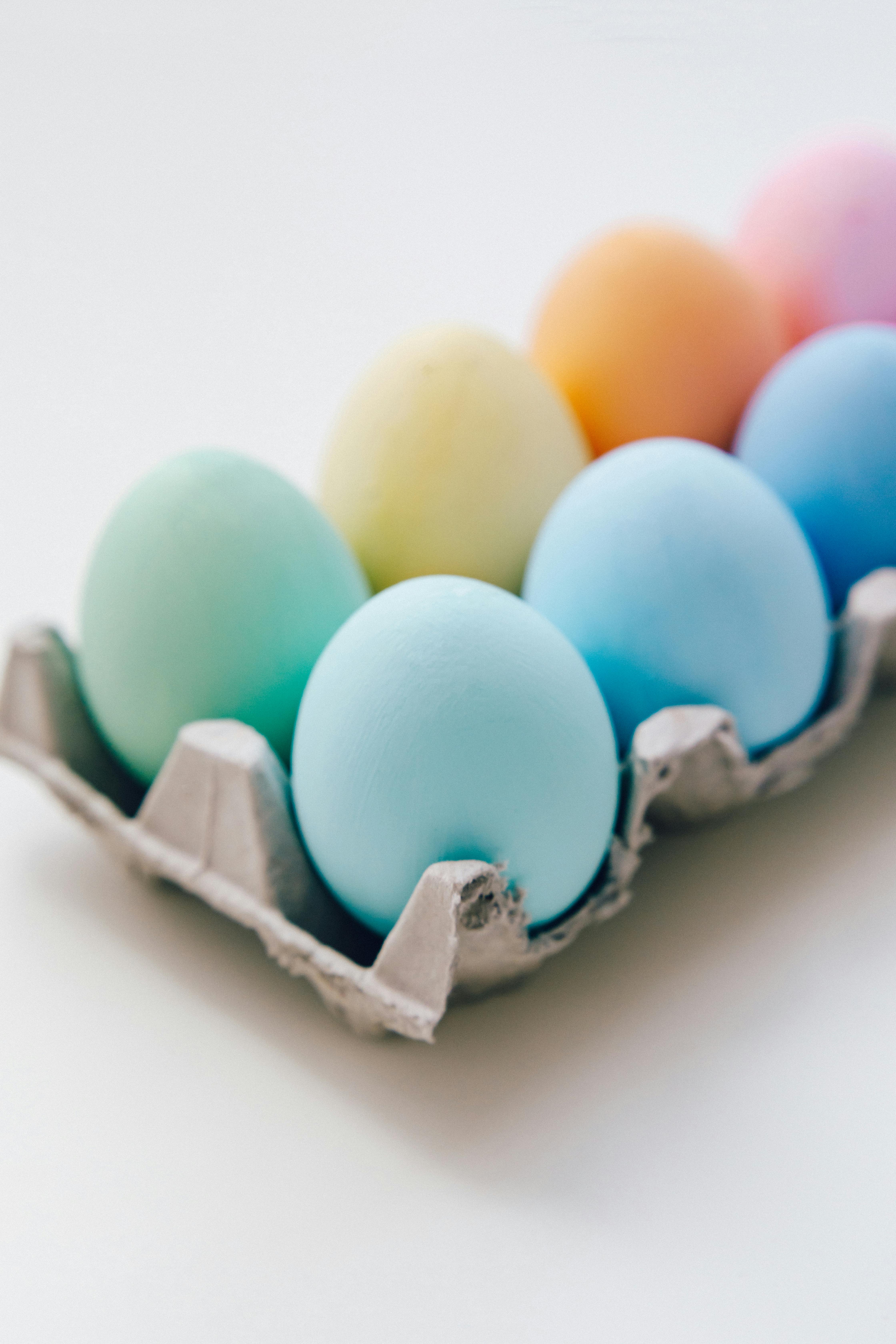 Pastel-colored Easter eggs arranged in a carton, perfect for festive spring decoration.