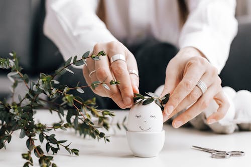 Person Decorating An Egg