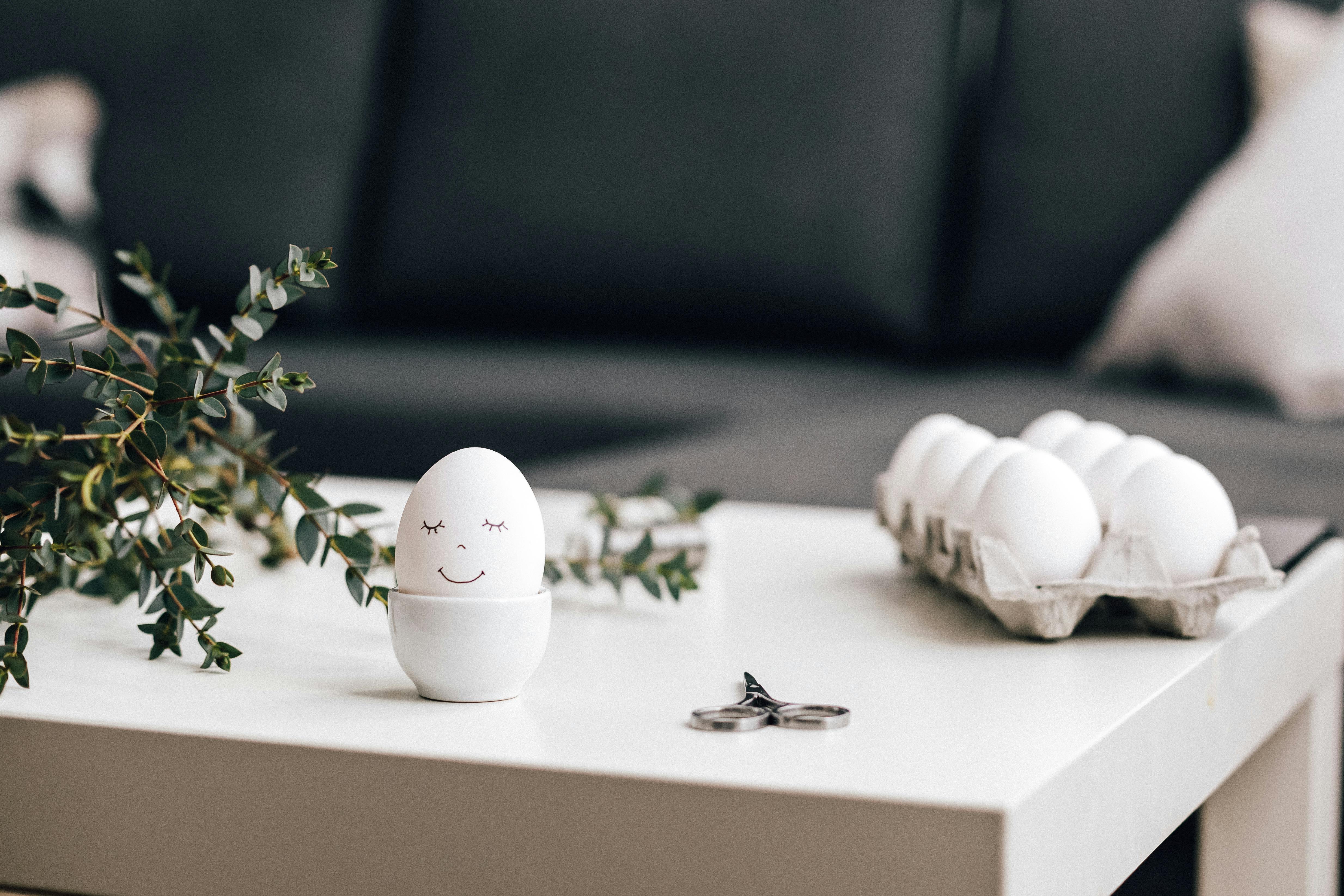 A minimalist Easter egg with a smiley face in a modern indoor setting.