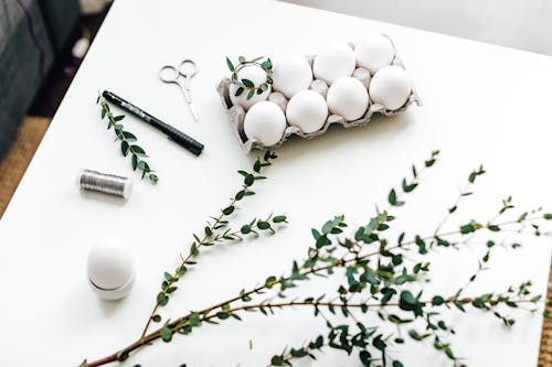 Carton Of White Eggs And Leaves On Table