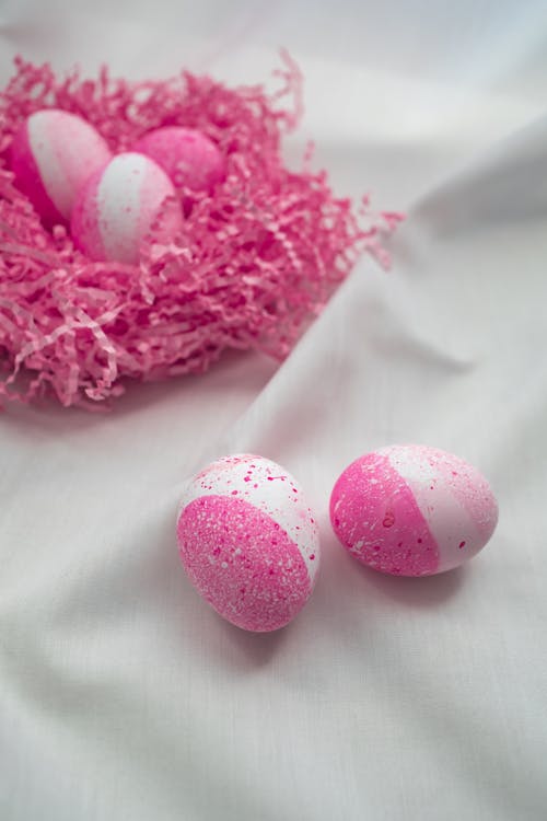 Free Pink Painted Easter Eggs on a White Textile Stock Photo