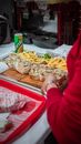 Person in Red Long Sleeves Shirt Preparing Food on the Wooden Tray