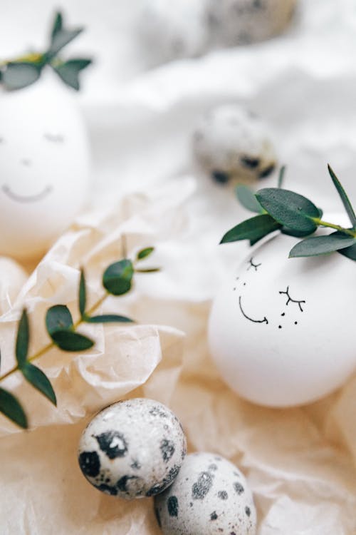 Free White Painted Eggs With Green Leaves Stock Photo