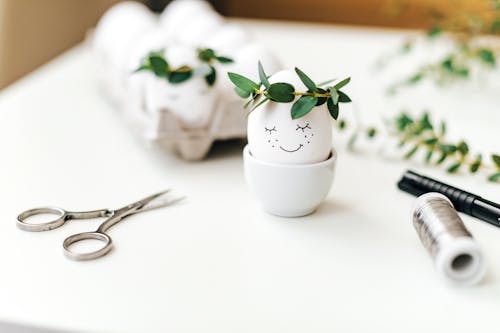 White Ceramic Pot With Painted Egg