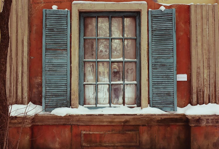 Window Of An Old Wooden House With Snow On The Ledge 