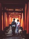 A Couple Wearing Kimonos Walking on Open Hallway