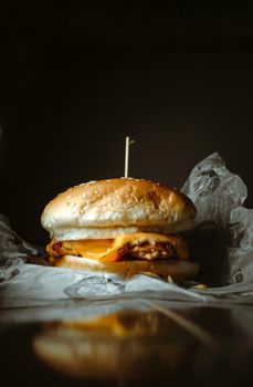 Delicious cheeseburger with melted cheese on a sesame seed bun, perfect for food photography.