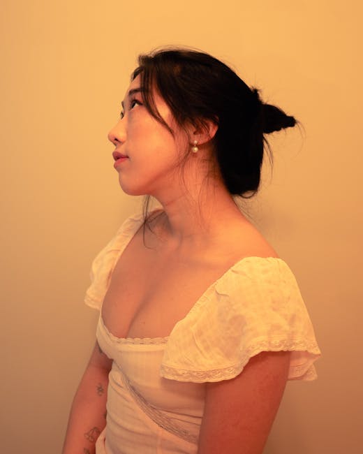 Side profile portrait of an elegant woman in soft, warm lighting, exuding natural beauty.