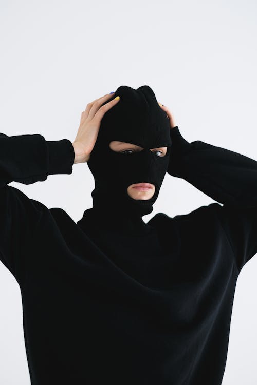 Close-Up Shot of a Person Wearing a Robber Mask