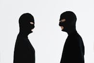 Close-Up Shot of Two People Wearing Robber Mask