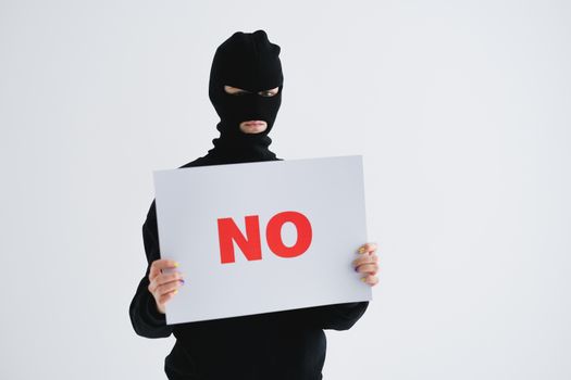 A Person in a Mask Holding a Sign