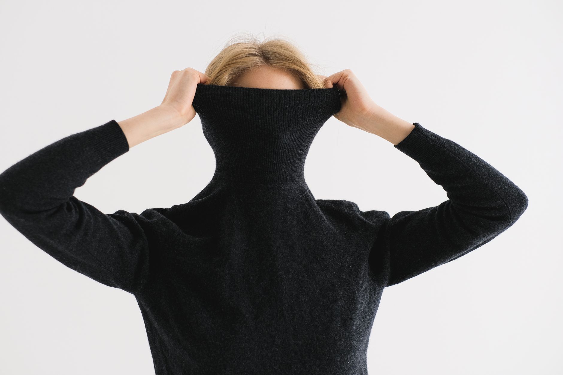 A folded wool sweater in soft natural light