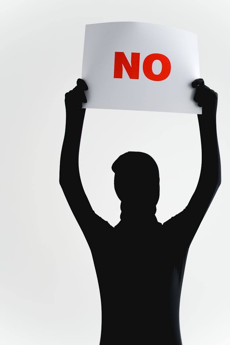 A Person In Black Long Sleeves Holding A Poster