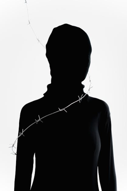 Person Wearing Black Zentai Suit with a Barbed Wire Circling the