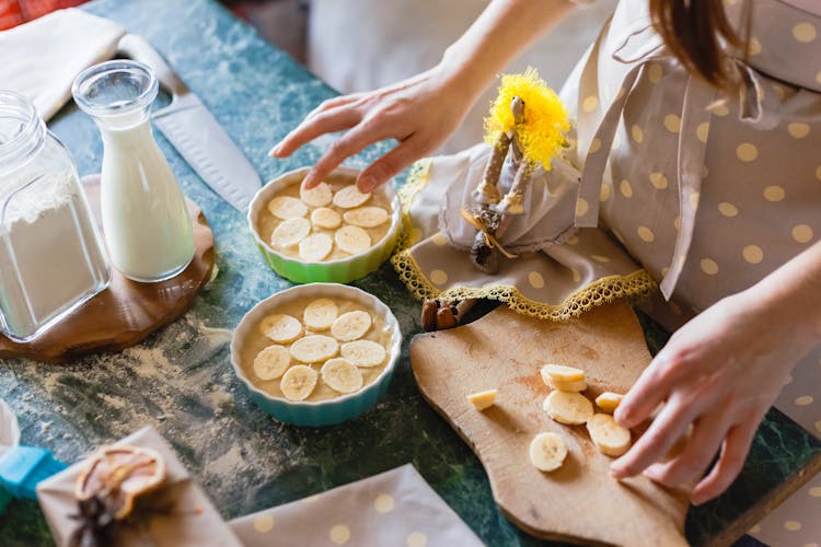 A Person Preparing Banana Oats On The Bowls