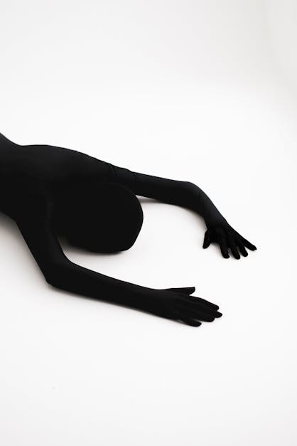 Person Wearing Black Zentai Suit with a Barbed Wire Circling the
