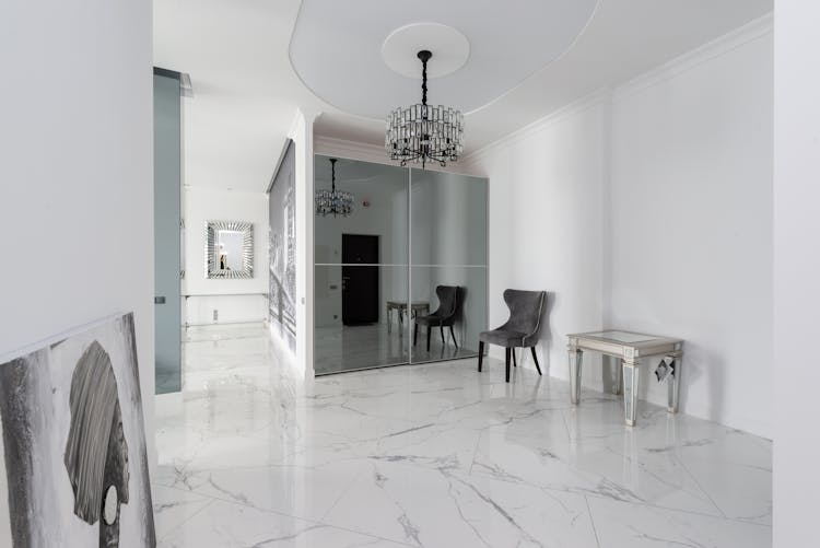 Hallway Interior With Chair And Table Near Mirror