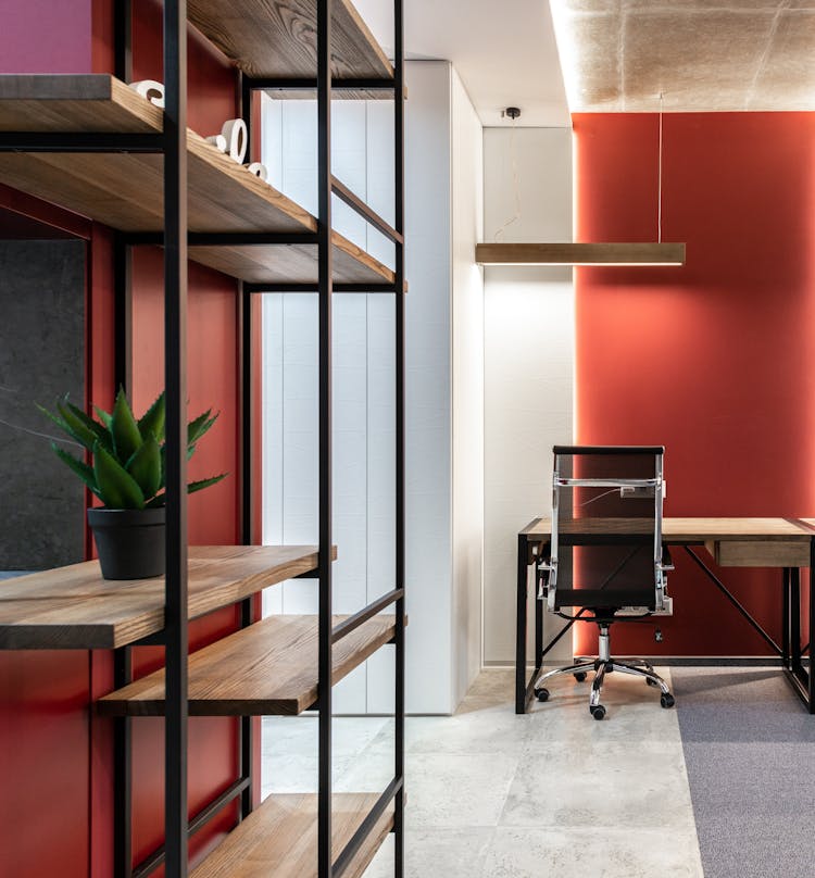 Office With Shelves Near Table And Chair