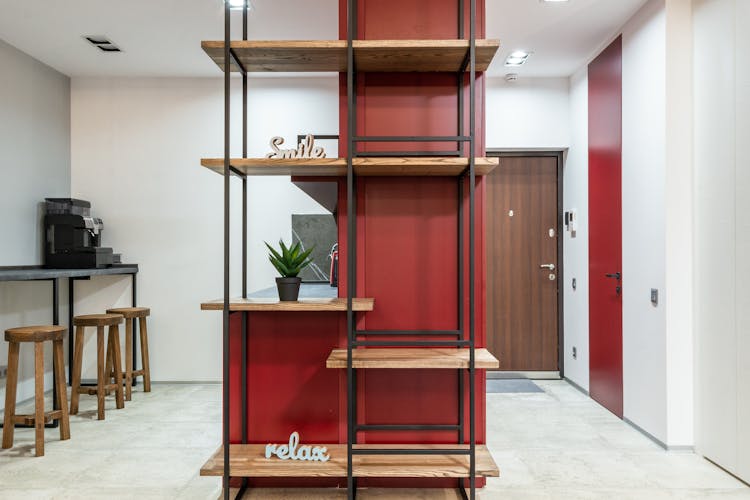 Office With Shelves Near Stools With Counter