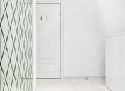 White room with closed door of restroom