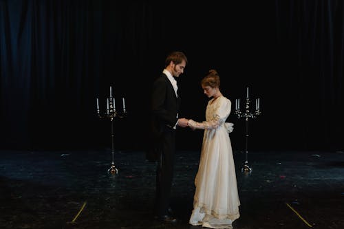 Man in Black Suit Standing Beside Woman in White Wedding Dress