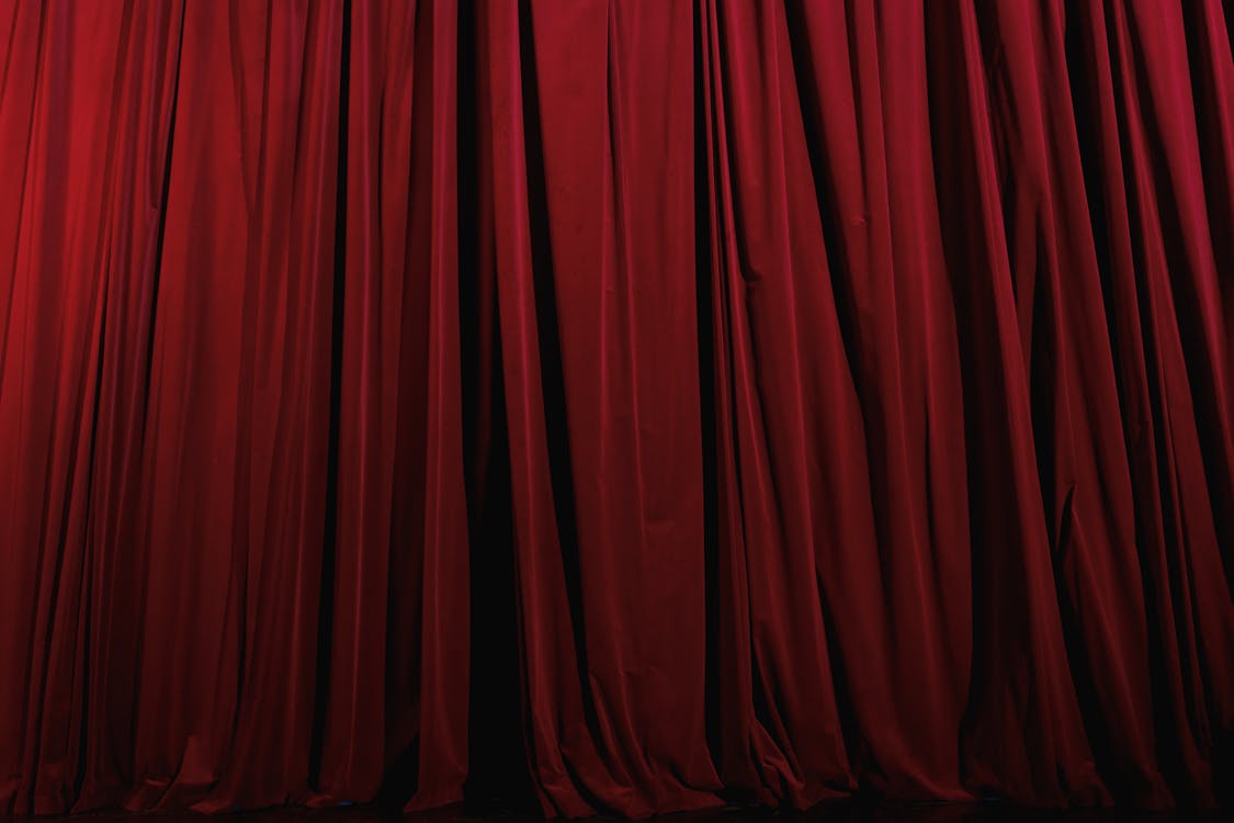 A Red Pleated Curtain on a Theater Stage