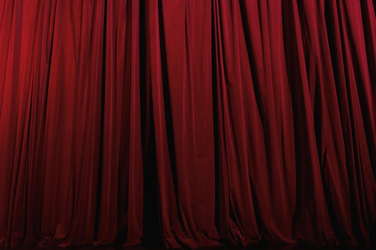 A Red Pleated Curtain On A Theater Stage