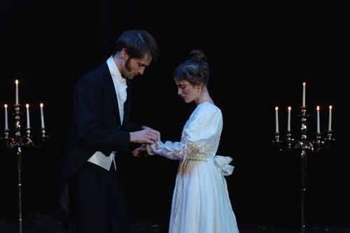 Free A dramatic scene depicting a romantic moment between two actors on stage. Stock Photo