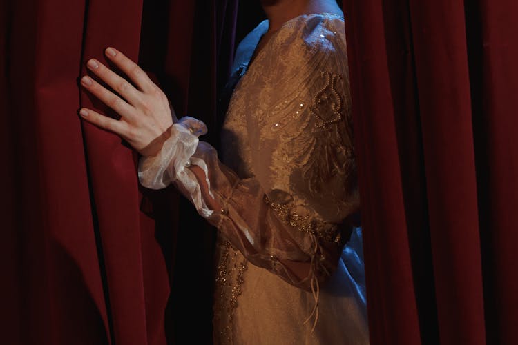 Crop Photo Of Woman Standing Behind A Curtain