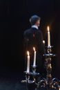 Blur Photo Of Man Standing Near A Candelabrum