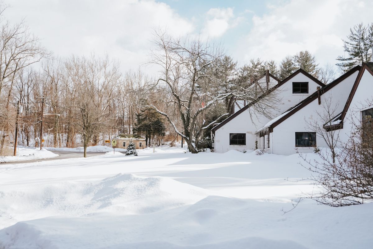 Snowy suburban houses in a BC winter where attic heat loss costs the most