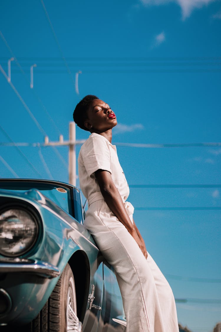 Stylish African American Woman Leaning On Car