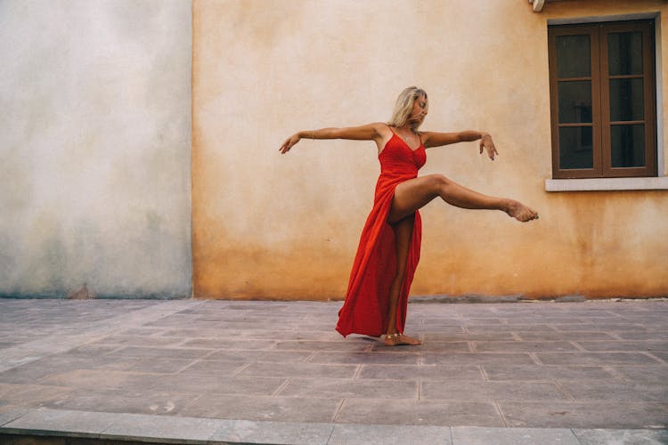 Woman In Red Dress Dancing On A Courtyard