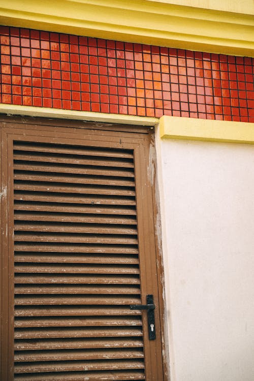 Wooden Door Under a Red Tiled Wall