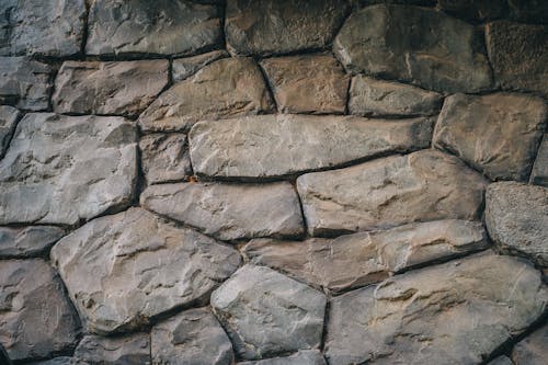 Free A Gray and Brown Stone Wall in Close-up Photography Stock Photo