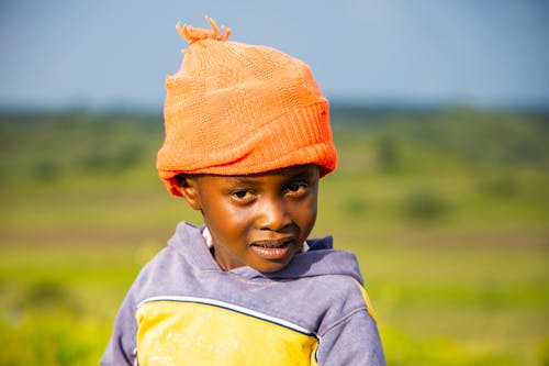 Free A Young Boy Wearing Orange Beanie Stock Photo