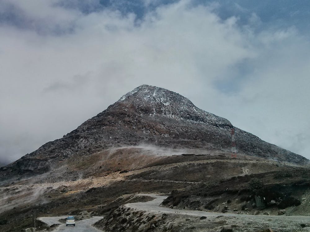 A Rocky Mountain Under White Clouds