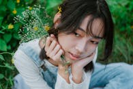 Portrait of a Young Woman Holding Flowers Outdoors