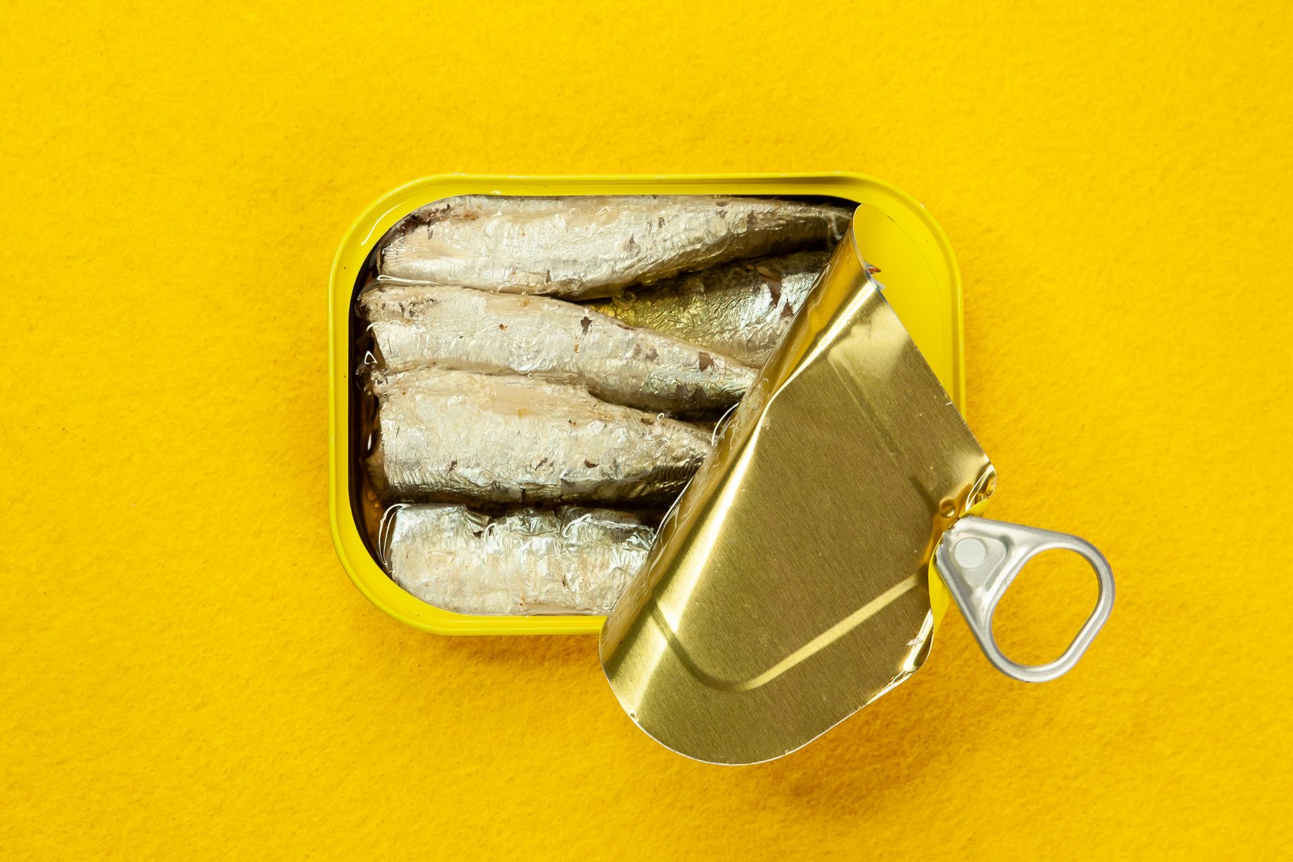 Camping tools and cans on a wooden surface outdoors