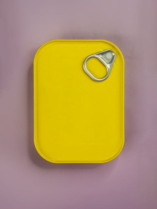 Free A Yellow Pull Tab Lid Can on a Purple Surface Stock Photo