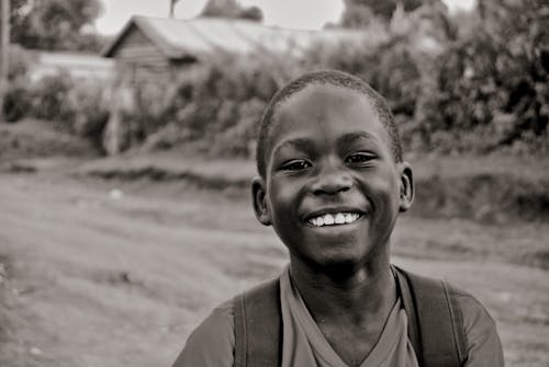 Monochrome Photo of a Boy Smiling