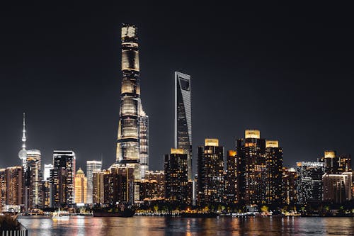The Illuminated Shanghai Tower with City Buildings at Night