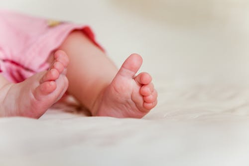 Free Baby's Feet on Bed  Stock Photo